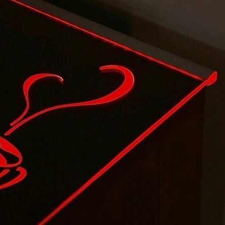 LASI10 LED-profiili lasin reunaan valaisee tyylikkäästi mustaa pintaa punaisella valolla.